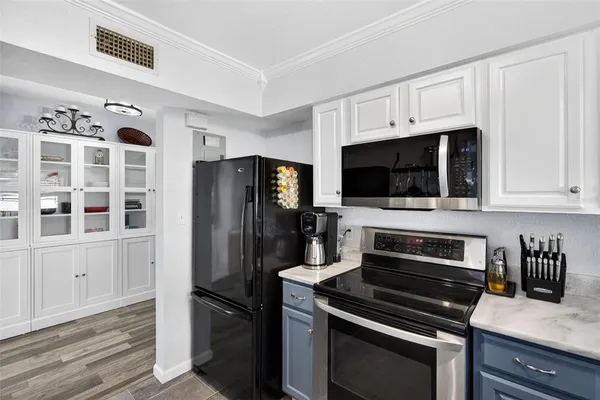 a kitchen with stainless steel appliances and chandelier