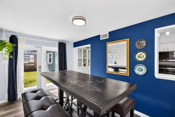 a living room with dining room and wooden floor