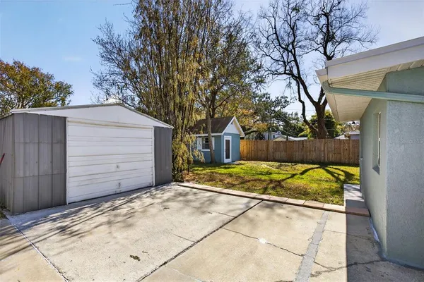 a view of backyard with wooden fence