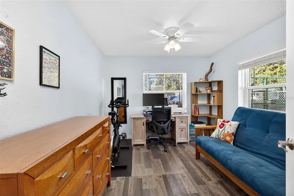 a living room with furniture and wooden floor