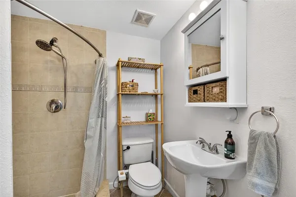 a bathroom with a sink toilet and shower