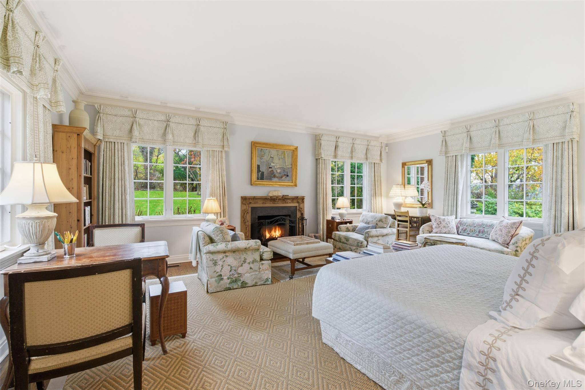 159 Factory Pond Road Mill Neck, NY 11560 - Photo 23 of 39 Bedroom featuring crown molding, a fireplace and multiple windows with view of the yard.