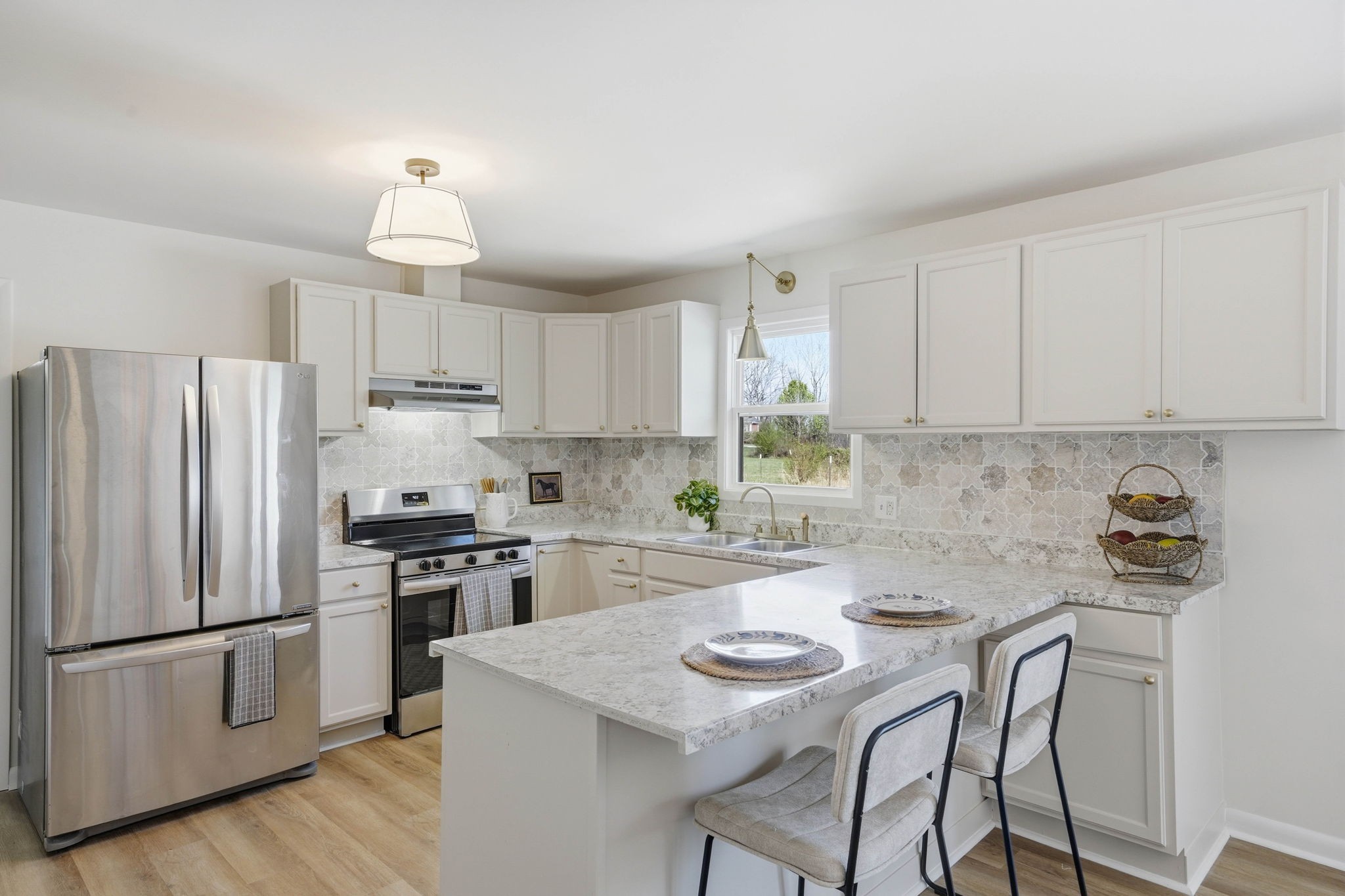 166 Bains Road Hillsboro, TN 37342 - Photo 8 of 37 a kitchen with stainless steel appliances a refrigerator a sink a stove a table and chairs