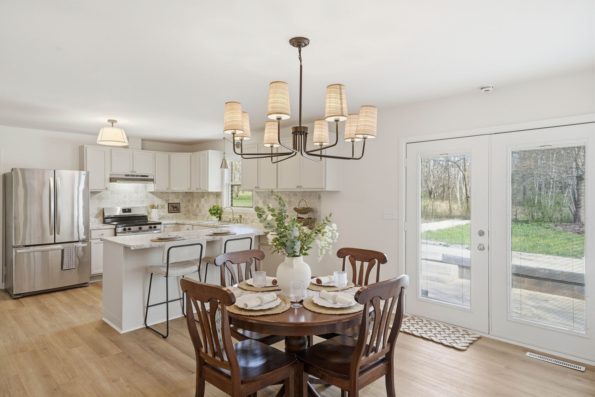 166 Bains Road Hillsboro, TN 37342 - Photo 10 of 37 a kitchen with stainless steel appliances a dining table chairs and chandelier