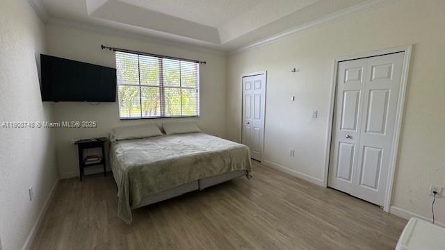 7844 Northwest 114th Path, Unit 7844 Doral, FL 33178 - Photo 17 of 18 a bedroom with a bed a flat screen tv and windows