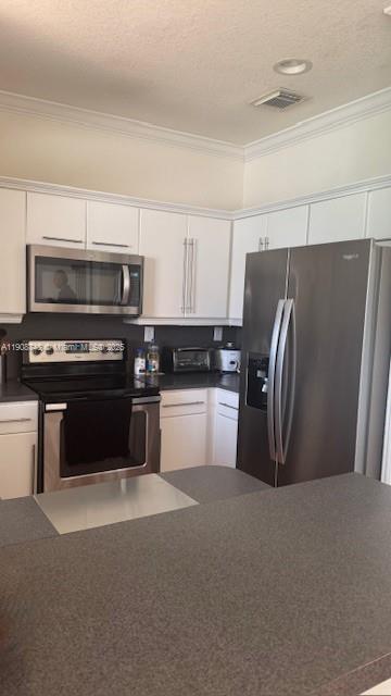 7844 Northwest 114th Path, Unit 7844 Doral, FL 33178 - Photo 5 of 18 a kitchen with stainless steel appliances and a refrigerator