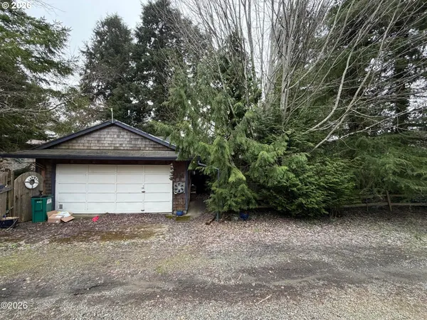 a view of a house with a yard and garage