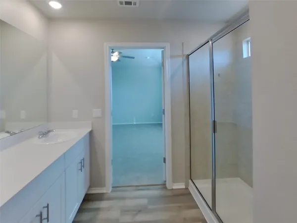 a bathroom with a double vanity sink mirror and shower