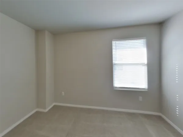 a view of an empty room with closet area