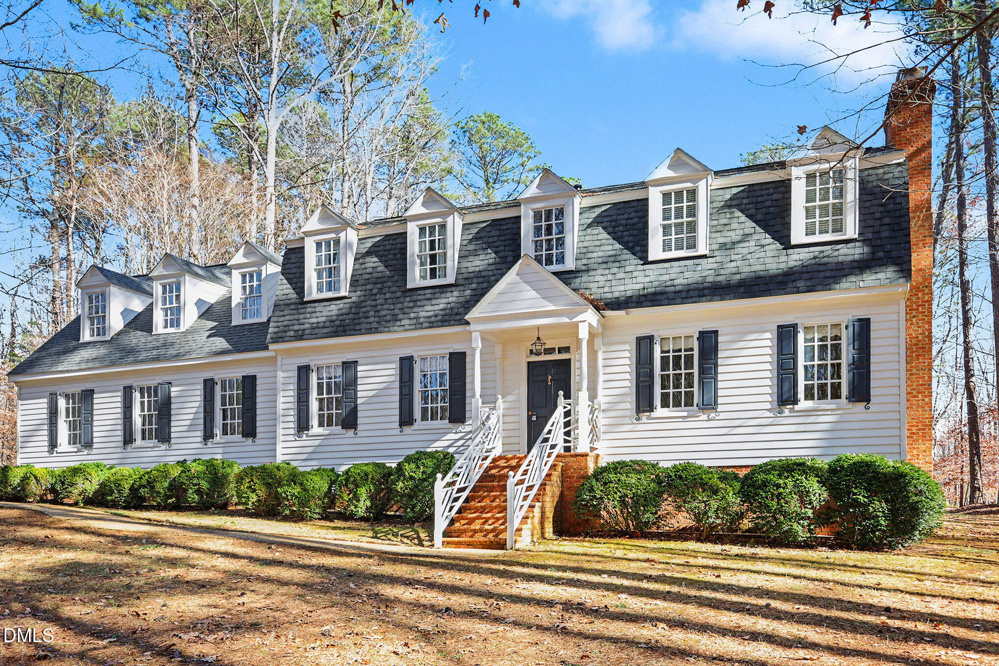 front view of a brick house next to a yard