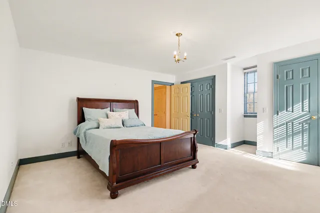 a spacious bedroom with a bed and a window