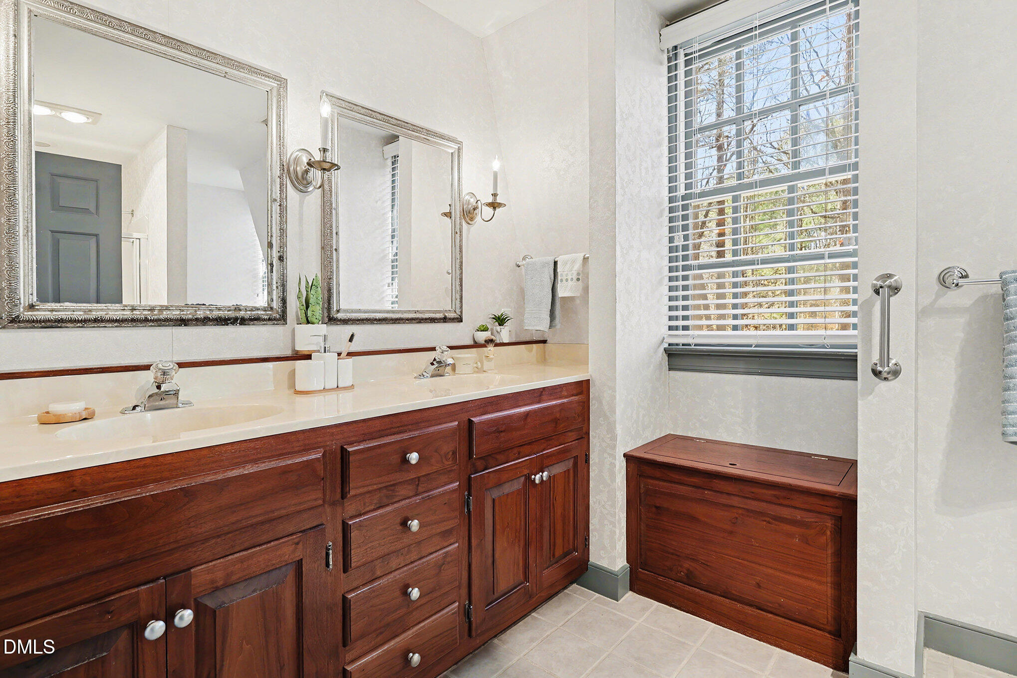 4604 Bartwood Drive Raleigh, NC 27613 - Photo 17 of 38 a bathroom with a sink a vanity and a mirror