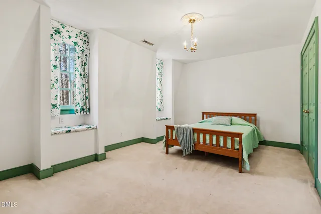 a spacious bedroom with a bed and a table