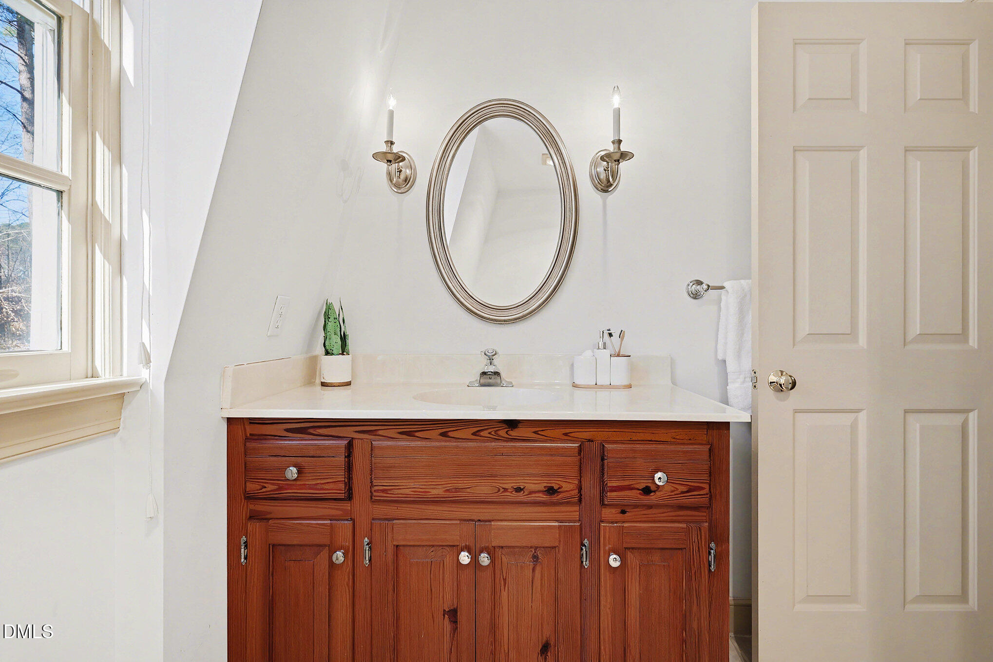 4604 Bartwood Drive Raleigh, NC 27613 - Photo 24 of 38 a bathroom with a sink and a mirror