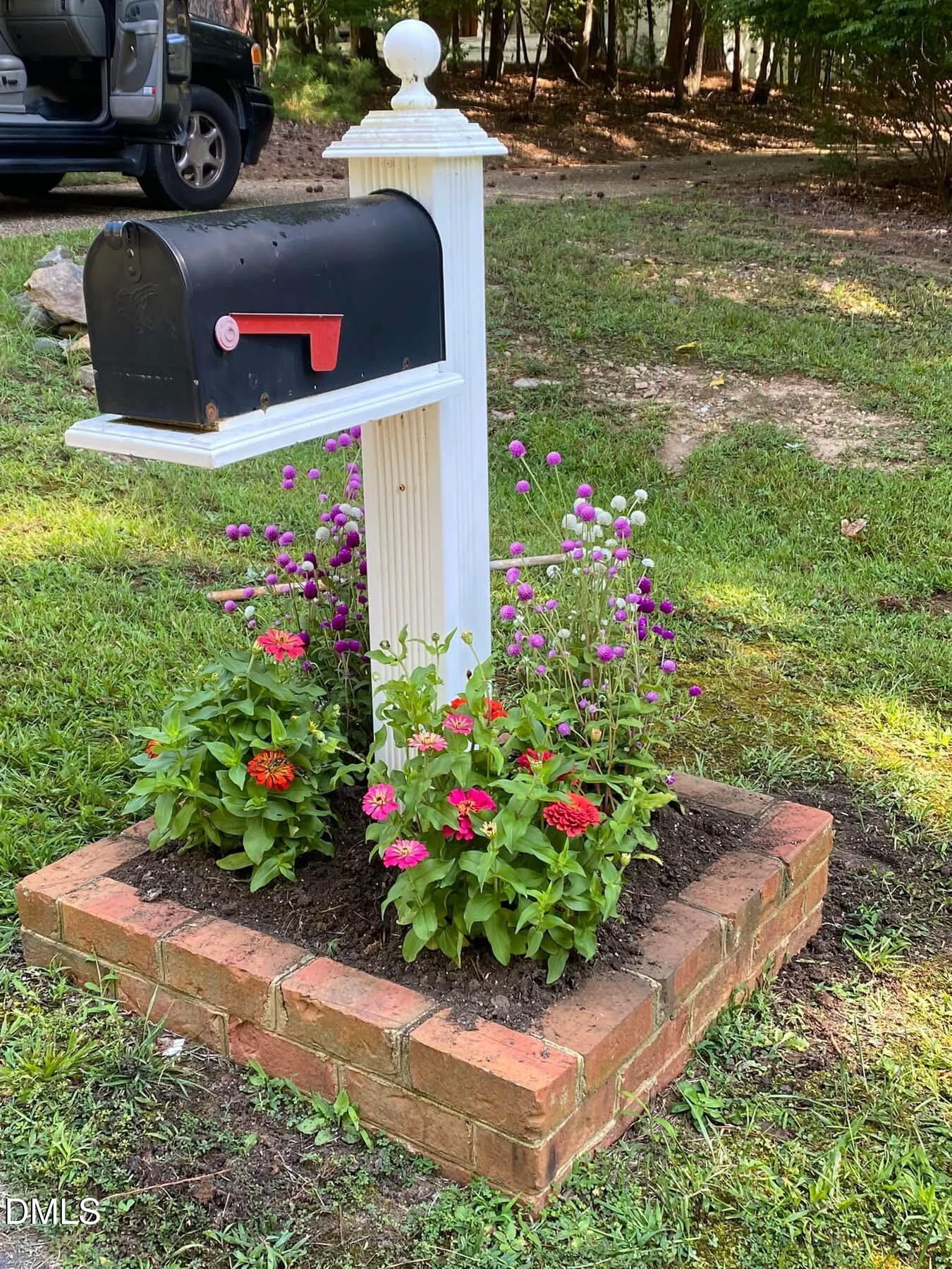 4604 Bartwood Drive Raleigh, NC 27613 - Photo 36 of 38 a bunch of flowers are in a yard