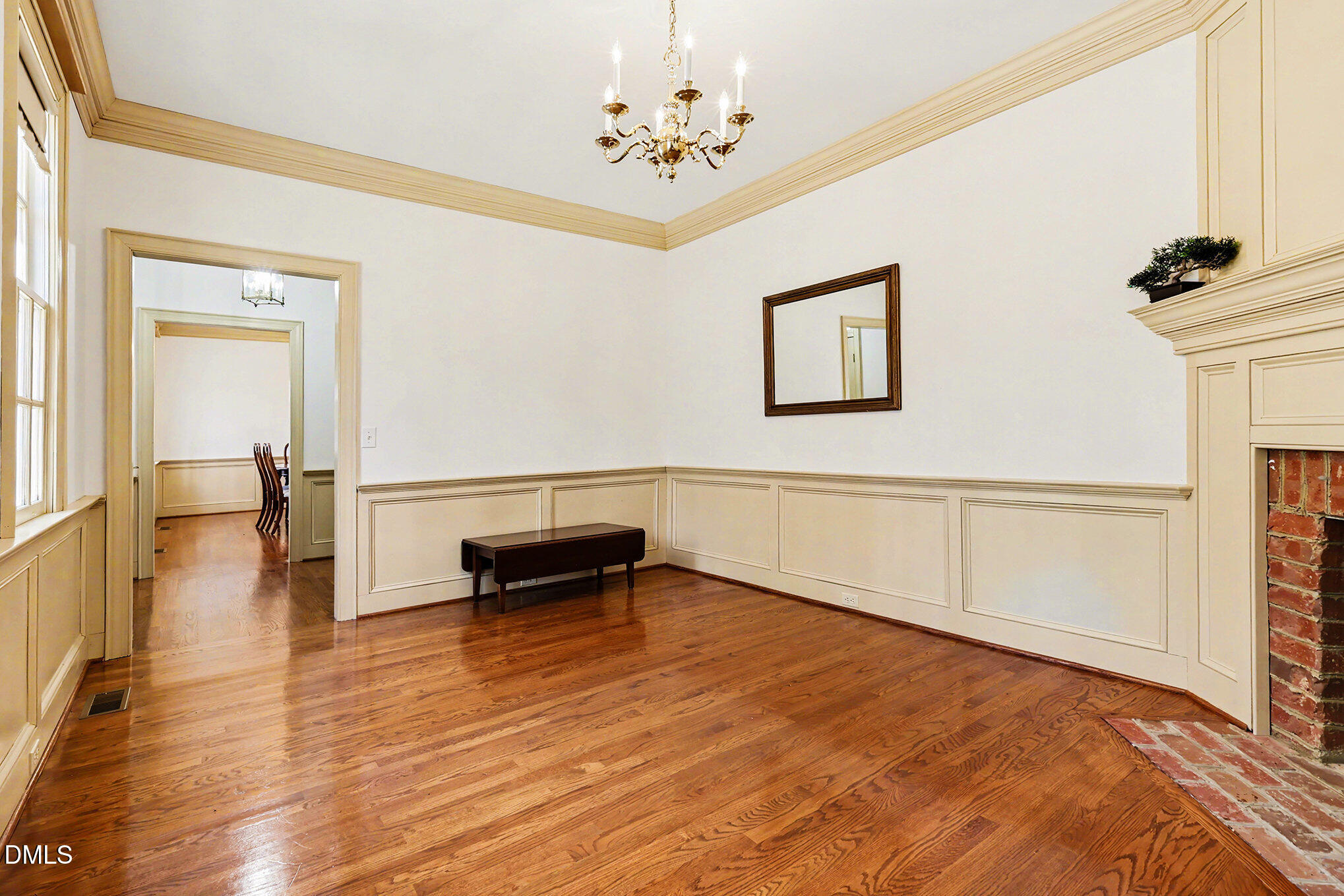 4604 Bartwood Drive Raleigh, NC 27613 - Photo 4 of 38 a view of an empty room with a window and wooden floor