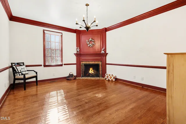a view of an empty room with a fireplace and a window