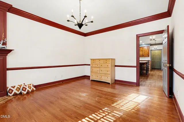 a view of an empty room and wooden floor