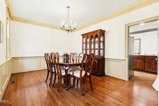 a view of a dining room with furniture wooden floor and chandelier