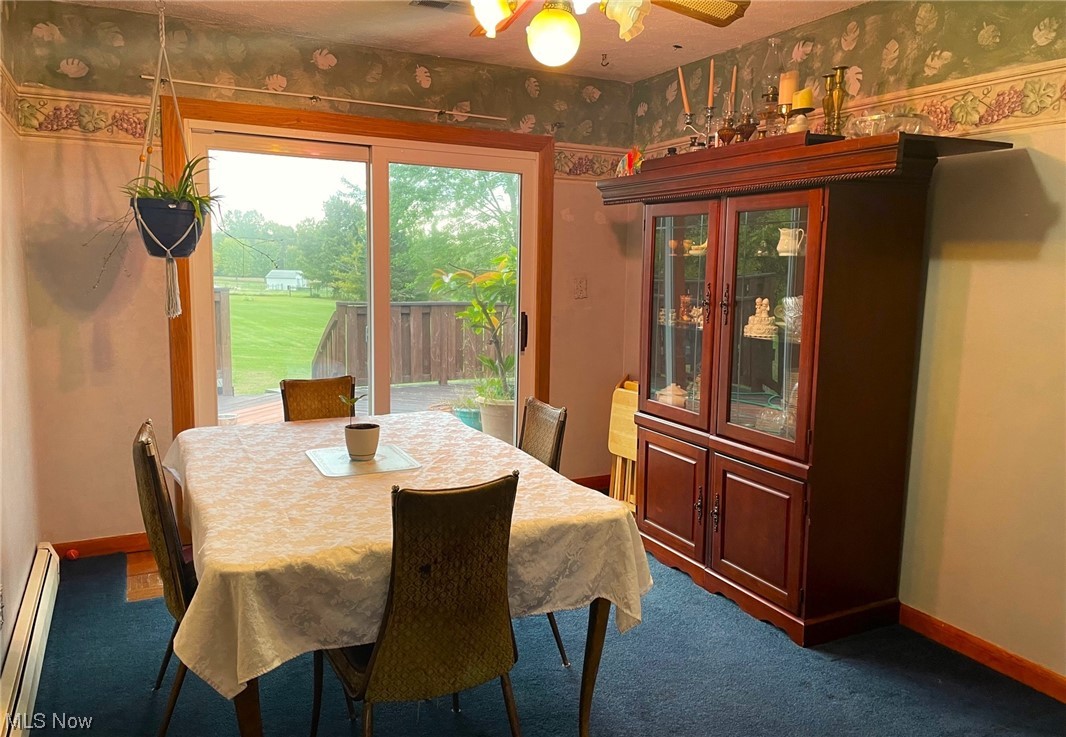 7297 Anderson Road Windham, OH 44288 - Photo 5 of 22 Dining area with baseboard heating, ceiling fan, and carpet flooring