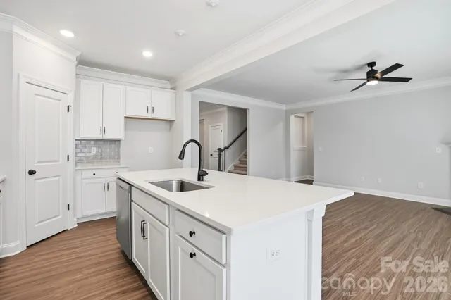a kitchen that has a sink and a stove in it