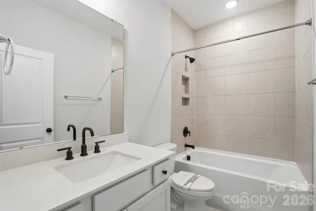 a bathroom with a sink a toilet and a bathtub