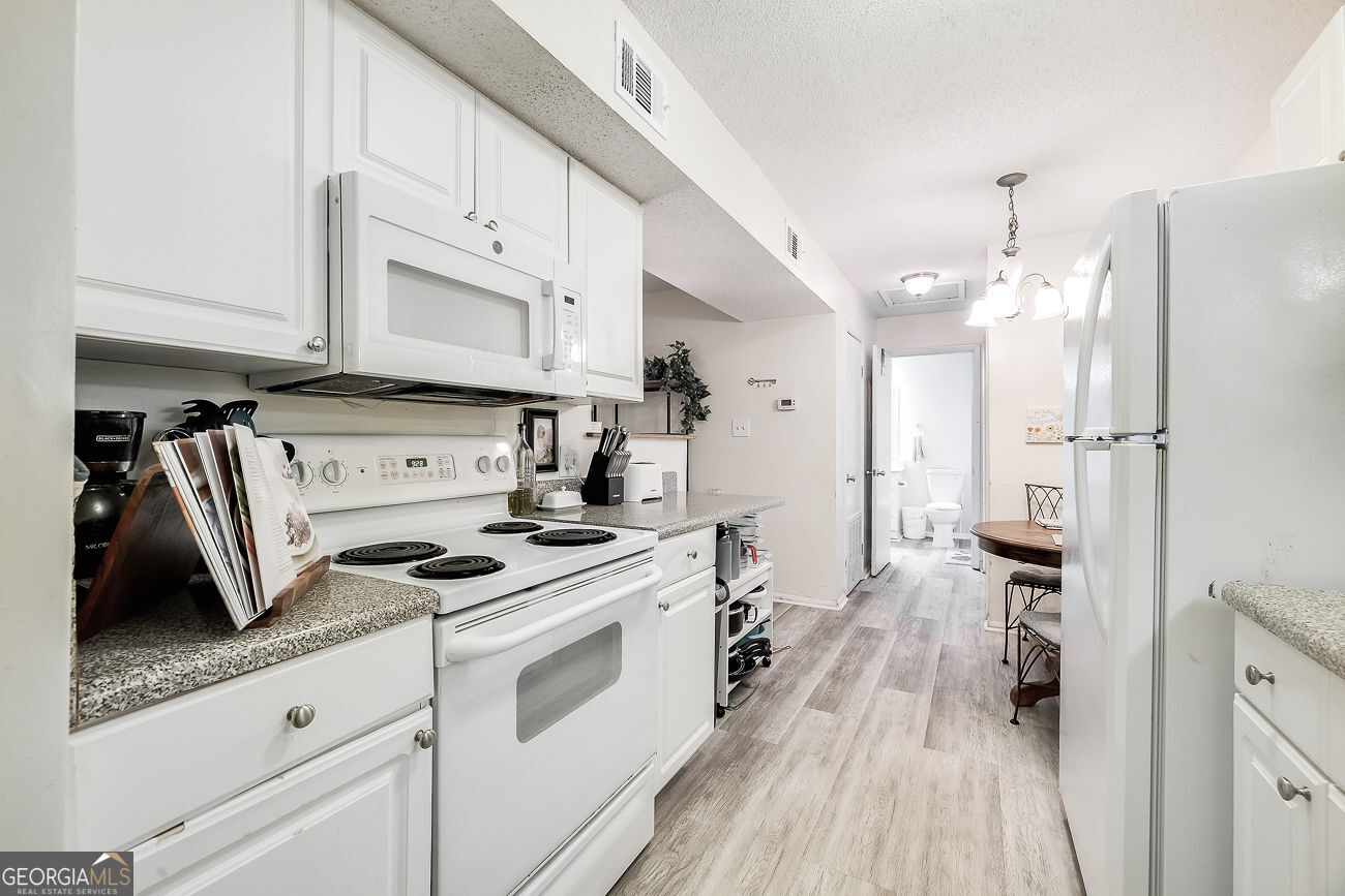 401 North Cromwell Road, Unit Q7 Savannah, GA 31410 - Photo 11 of 21 a kitchen with stainless steel appliances a stove a sink and a refrigerator