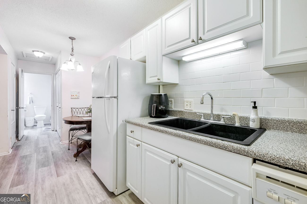401 North Cromwell Road, Unit Q7 Savannah, GA 31410 - Photo 12 of 21 a kitchen with a sink and cabinets