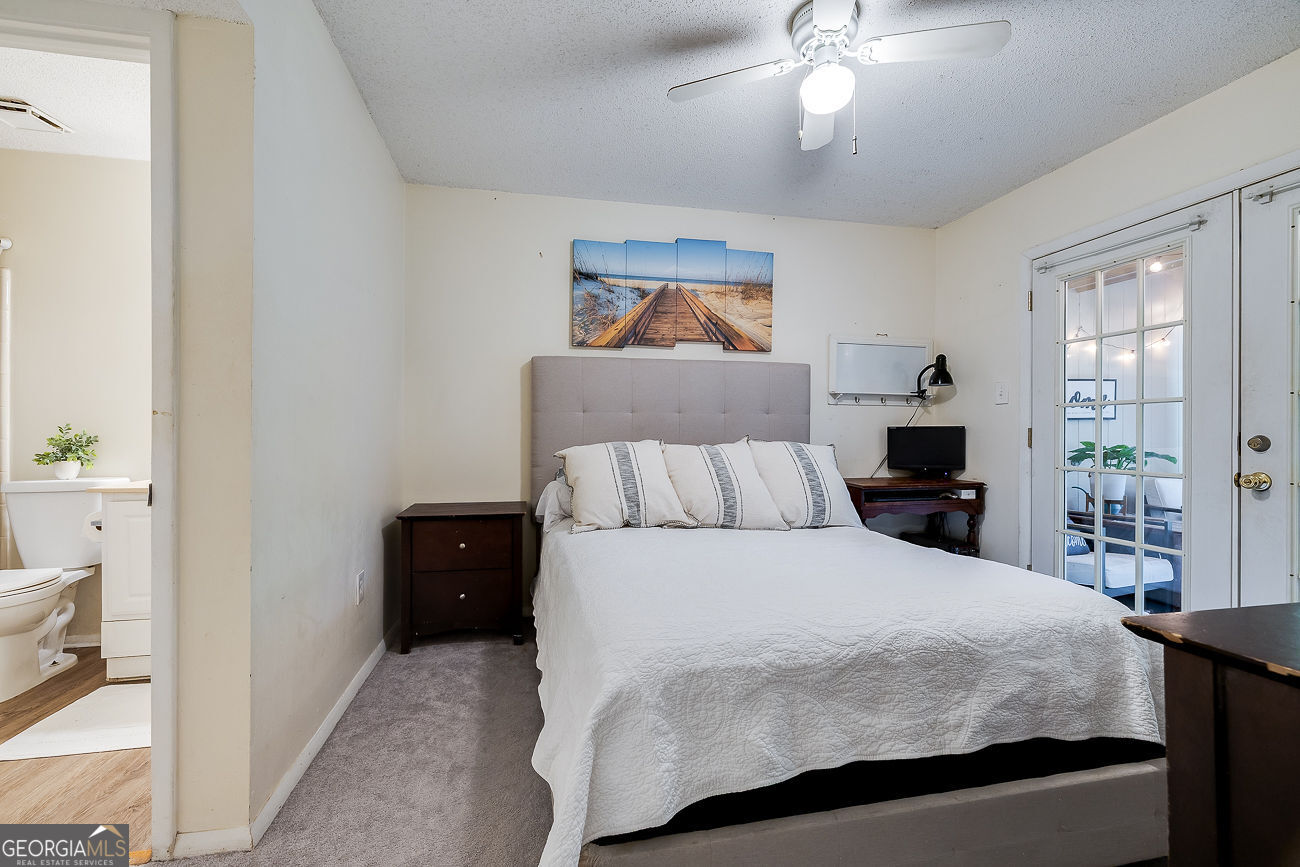 401 North Cromwell Road, Unit Q7 Savannah, GA 31410 - Photo 13 of 21 a bedroom with a bed and a chandelier