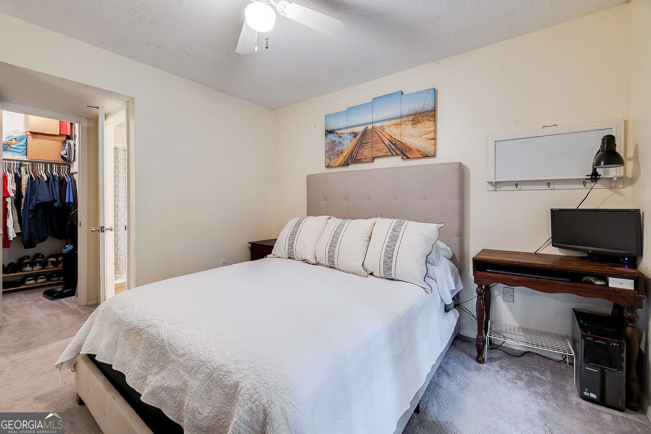 401 North Cromwell Road, Unit Q7 Savannah, GA 31410 - Photo 14 of 21 a bedroom with a bed and a flat screen tv