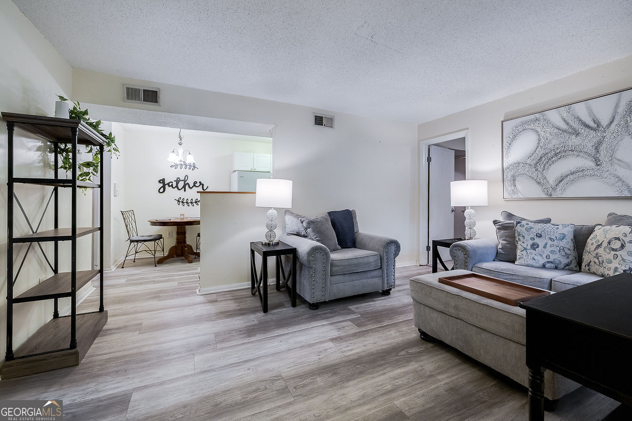 401 North Cromwell Road, Unit Q7 Savannah, GA 31410 - Photo 4 of 21 a living room with furniture and wooden floor