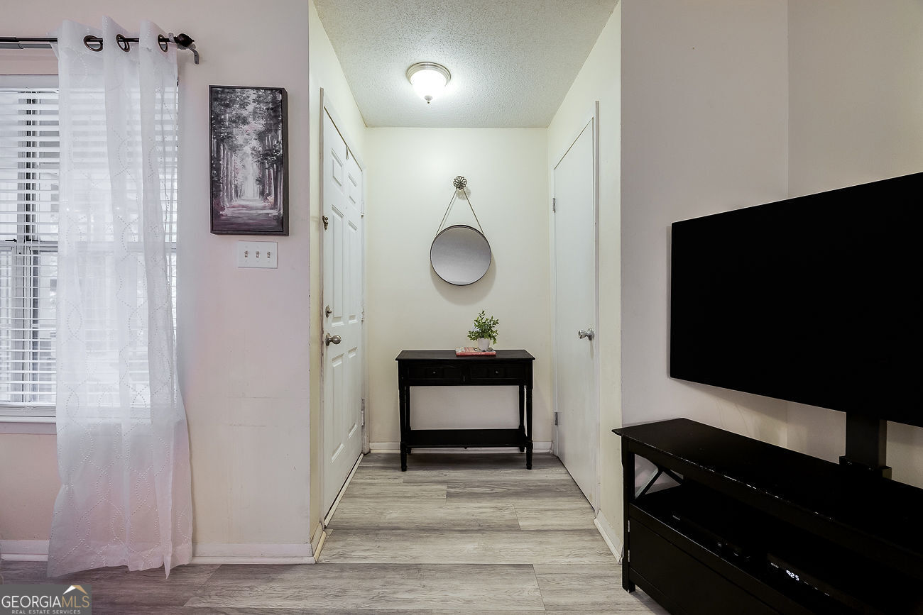 401 North Cromwell Road, Unit Q7 Savannah, GA 31410 - Photo 7 of 21 a living room with furniture and a flat screen tv