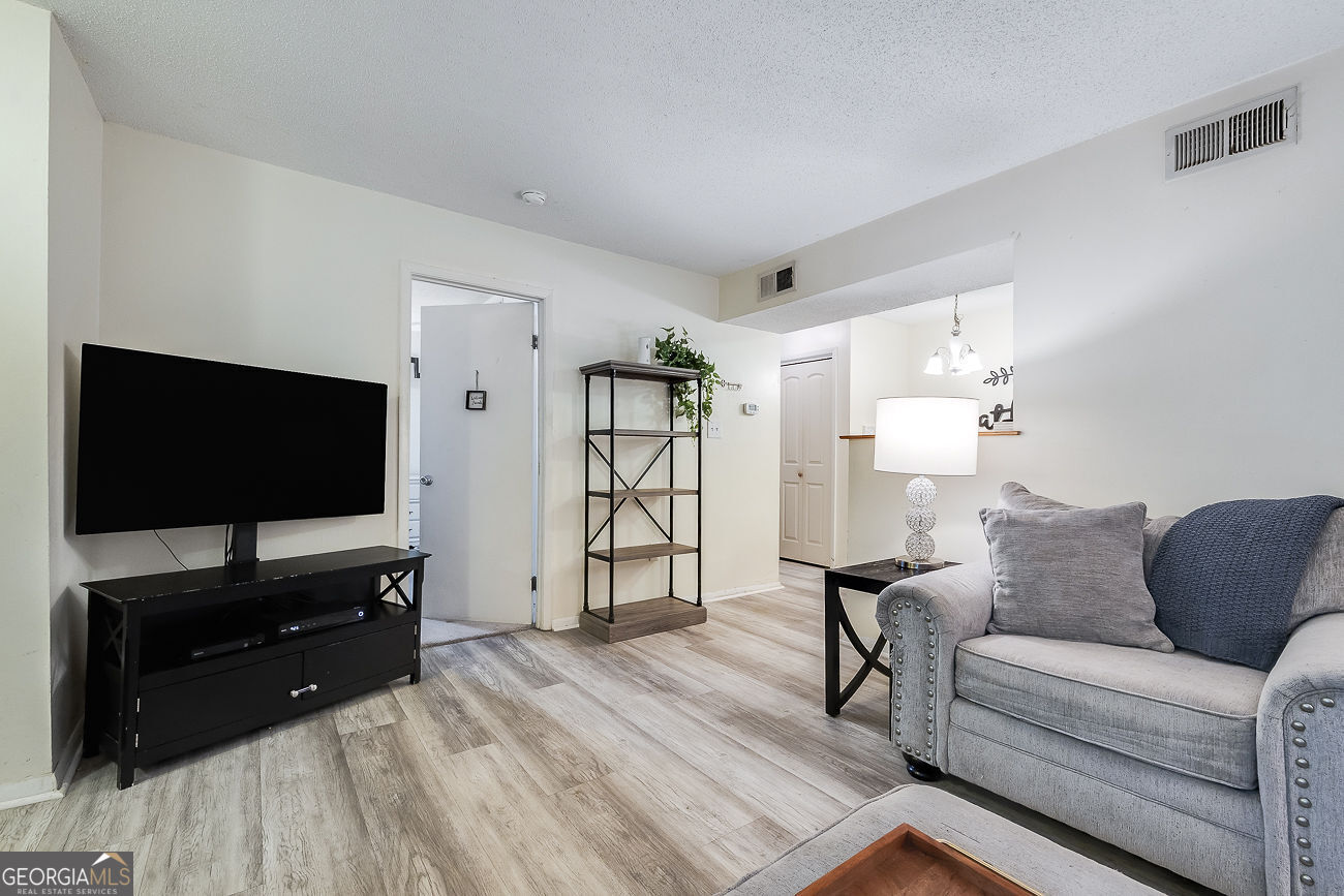 401 North Cromwell Road, Unit Q7 Savannah, GA 31410 - Photo 9 of 21 a living room with furniture and a flat screen tv