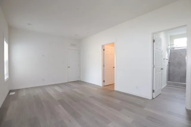 a view of an empty room and wooden floor