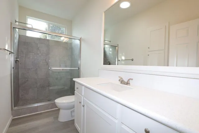 a bathroom with a sink toilet and shower
