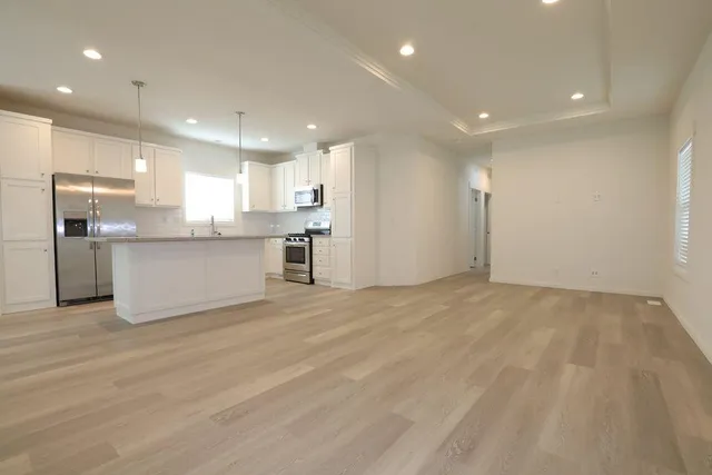 a view of a kitchen with a sink and a refrigerator