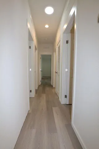 a view of a hallway with wooden floor