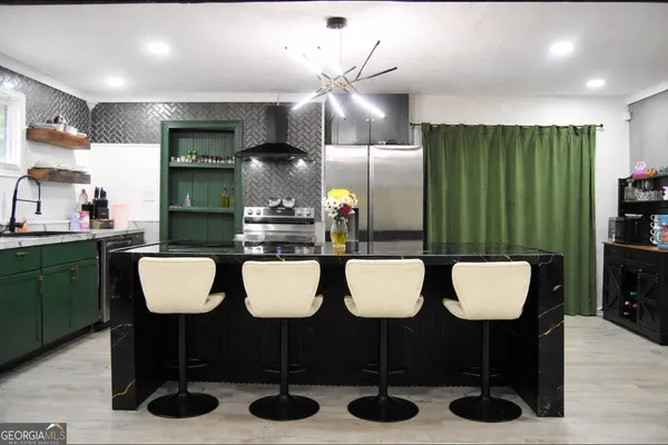 a kitchen with a dining table cabinets and chairs