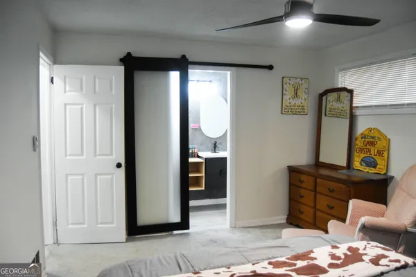 a bedroom with furniture and a window