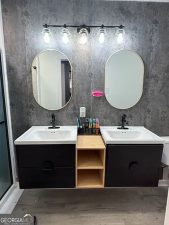 a bathroom with a double vanity sink and a mirror