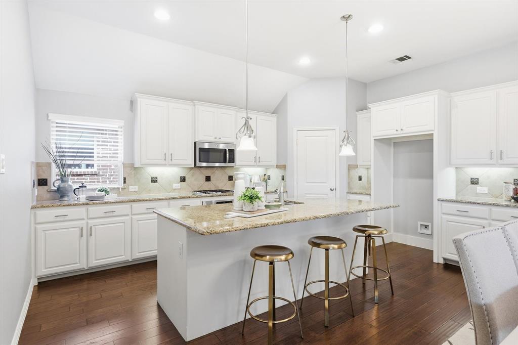 9728 Bitterroot Drive Little Elm, TX 75068 - Photo 14 of 39 Great kitchen space with SS appliances, large pantry, bar top seating, and ample storage.