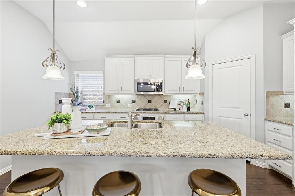 9728 Bitterroot Drive Little Elm, TX 75068 - Photo 16 of 39 Great kitchen space with SS appliances, large pantry, bar top seating, and ample storage.