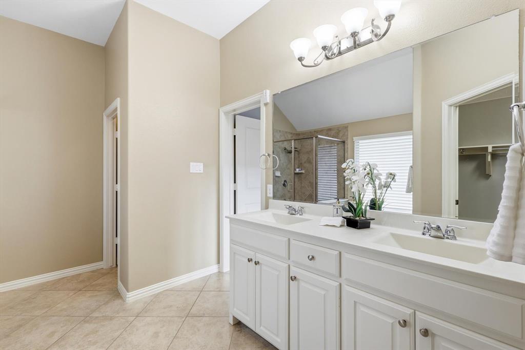 9728 Bitterroot Drive Little Elm, TX 75068 - Photo 20 of 39 Full bath featuring a shower stall, double vanity, and light tile patterned floors