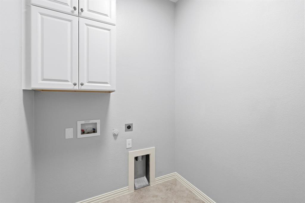 9728 Bitterroot Drive Little Elm, TX 75068 - Photo 30 of 39 Large laundry with ample amounts of cabinet space.