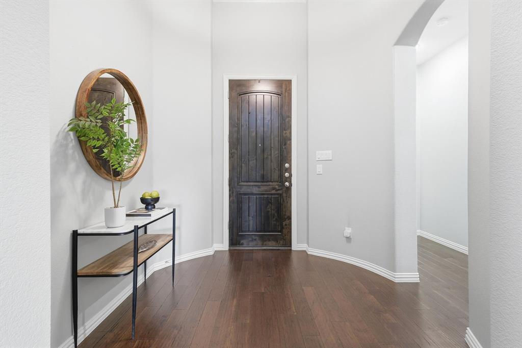 9728 Bitterroot Drive Little Elm, TX 75068 - Photo 5 of 39 Entry into home with gorgeous hardwood flooring, solid oak front door, bright light throughout and rotunda entry.