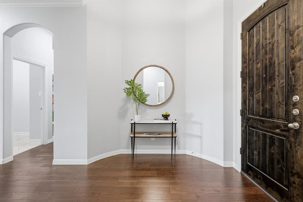 9728 Bitterroot Drive Little Elm, TX 75068 - Photo 6 of 39 Entry into home with gorgeous hardwood flooring, solid oak front door, bright light throughout and rotunda entry.