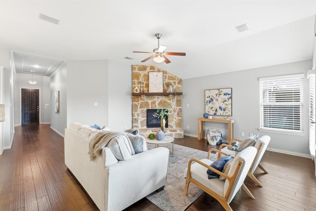 9728 Bitterroot Drive Little Elm, TX 75068 - Photo 8 of 39 Large living space with open concept to dining and kitchen. Natural light, gas fireplace and surround sound with norman shades.