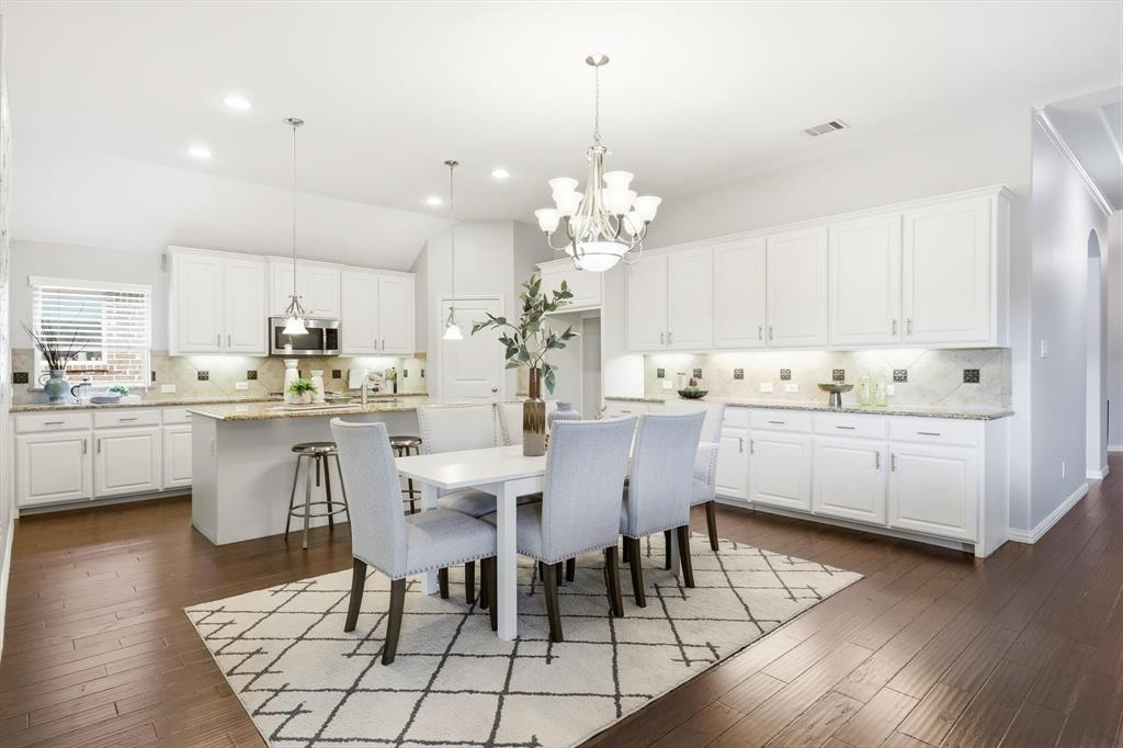 9728 Bitterroot Drive Little Elm, TX 75068 - Photo 10 of 39 Open Concept dining space splitting the kitchen and the living with ample storage, & counterspace.