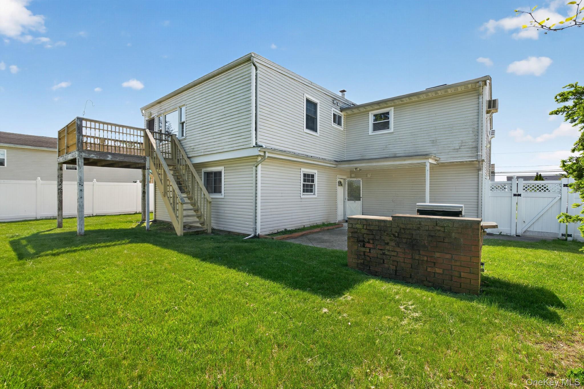 138 Spring Street Massapequa, NY 11758 - Photo 43 of 45 a backyard of a house with table and chairs