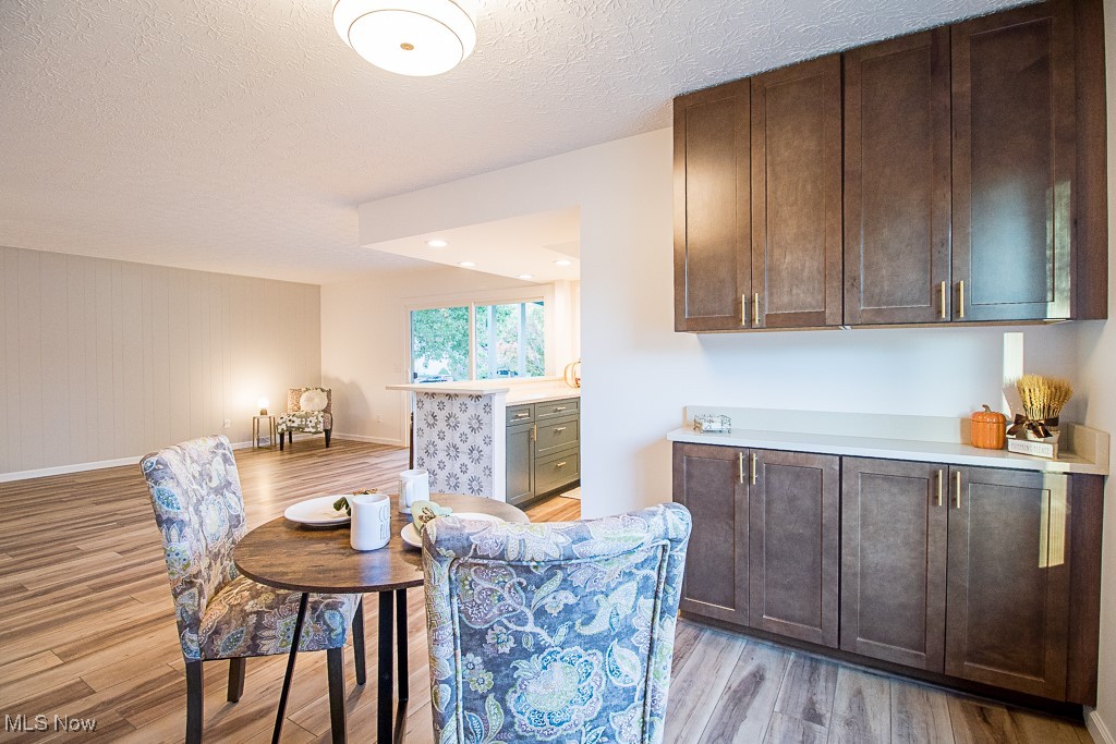 7041 Hopkins Road Mentor, OH 44060 - Photo 13 of 46 Dining room makes entertaining a breeze with a beautiful dark wood shaker style hutch, accented with gold hardware and a quartz countertop makes it an added bonus for extra storage